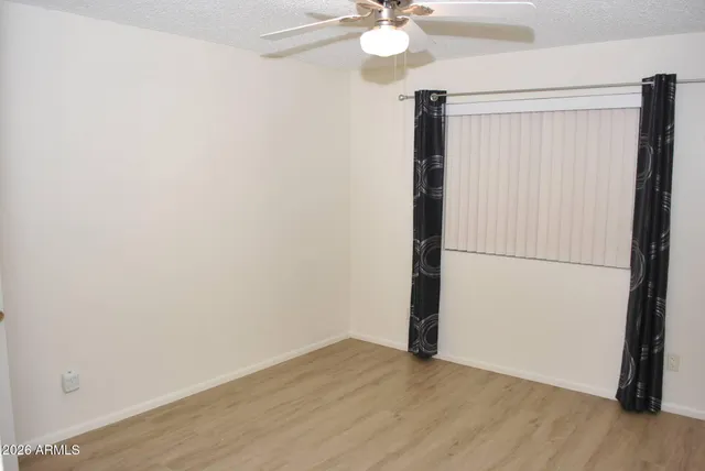 a view of a room with wooden floor