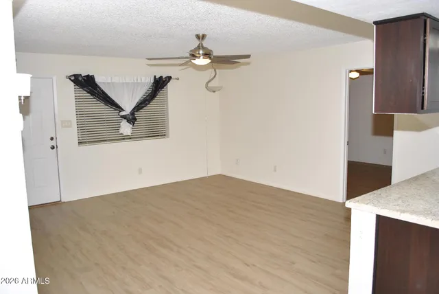 a view of a room with wooden floor and cabinet