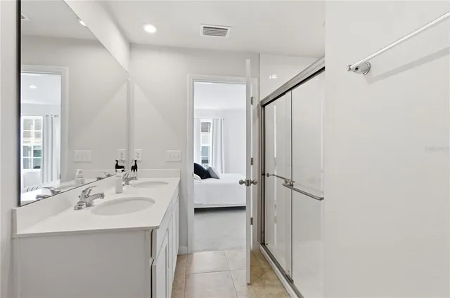 a bathroom with a sink a mirror and a shower