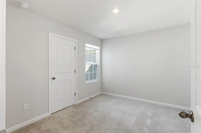 an empty room with a empty space and windows