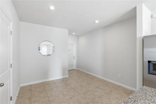 an empty room with wooden floor and cabinets