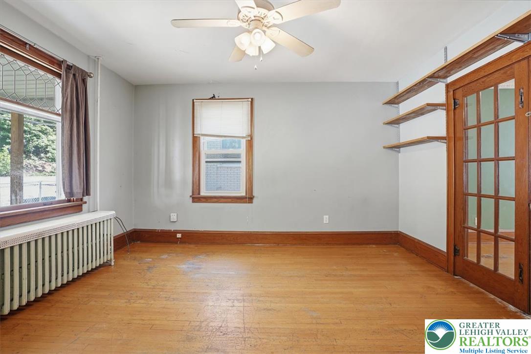 167 Main Road Lehighton, PA 18235 - Photo 8 of 41 Well-lit room with wood flooring, ceiling fan, and built-in shelving offers a functional space.