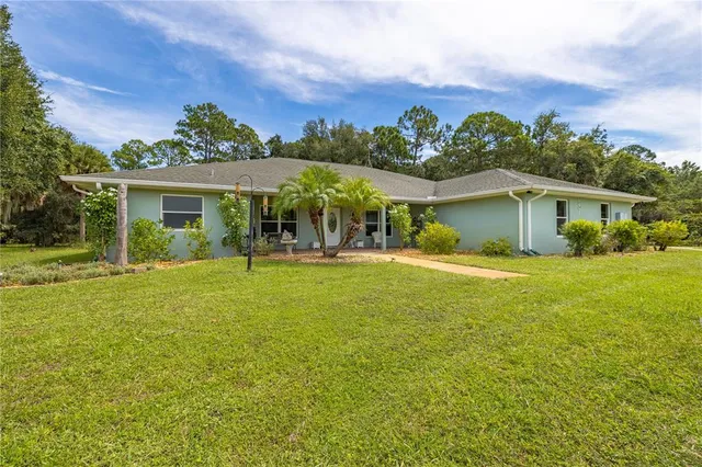 a front view of house with yard and green space