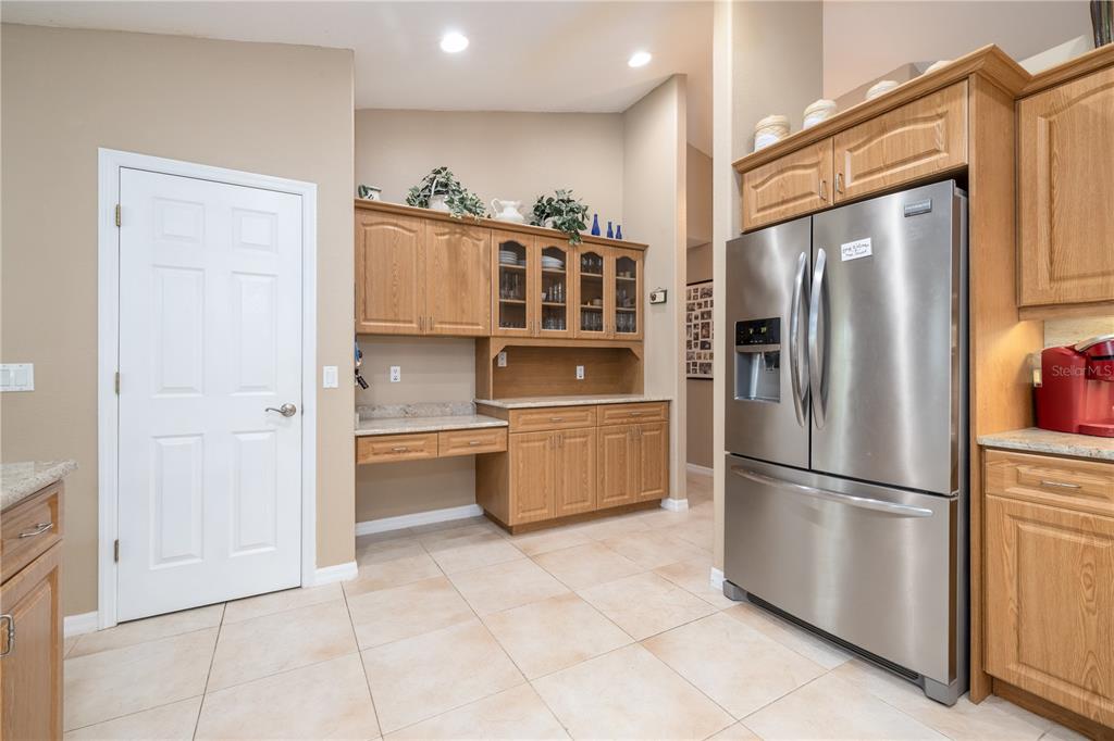 4245 Clinton Cemetery Road Edgewater, FL 32141 - Photo 11 of 60 a kitchen with stainless steel appliances a refrigerator and a stove top oven