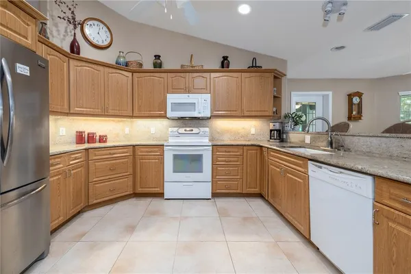 a kitchen with refrigerator and cabinets