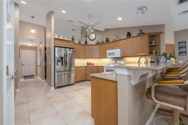 a kitchen with stainless steel appliances granite countertop a stove sink and cabinets