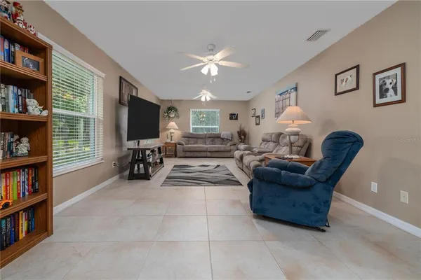a room with lots of furniture and a book shelf