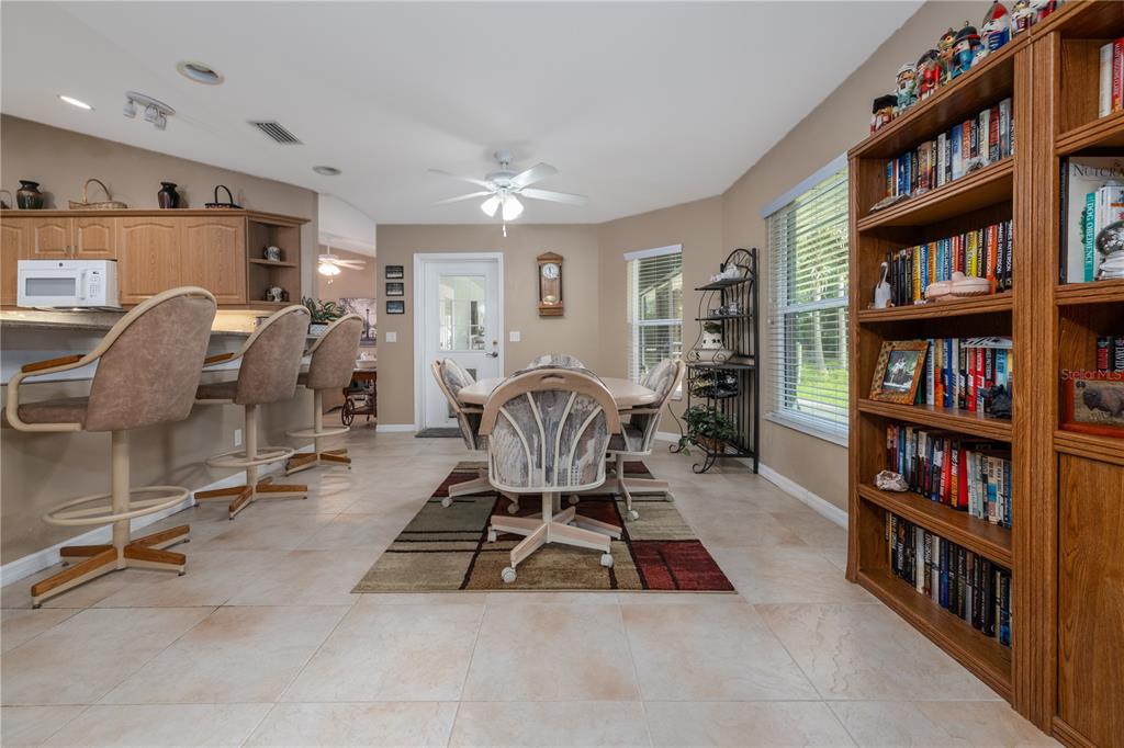 4245 Clinton Cemetery Road Edgewater, FL 32141 - Photo 16 of 60 a room with lots of furniture and a book shelf