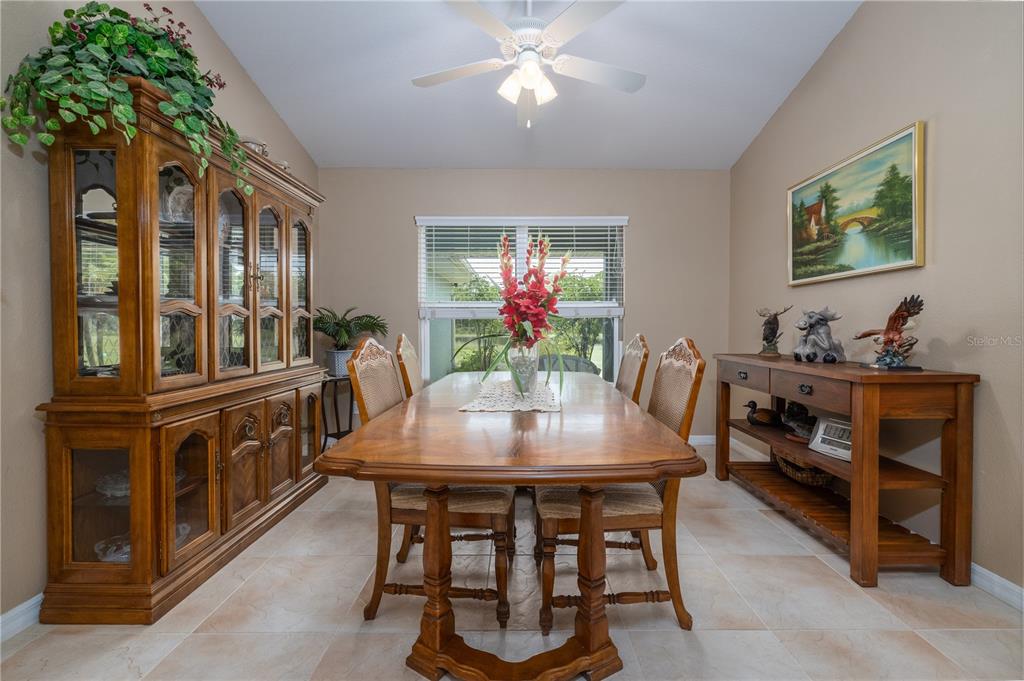 4245 Clinton Cemetery Road Edgewater, FL 32141 - Photo 17 of 60 a view of a dining room with furniture and chandelier