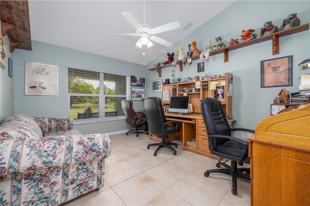 4245 Clinton Cemetery Road Edgewater, FL 32141 - Photo 18 of 60 a view of a workspace with furniture and a window