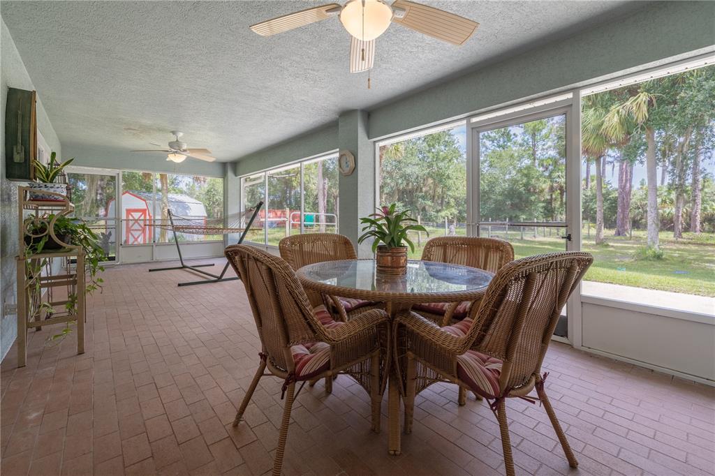 4245 Clinton Cemetery Road Edgewater, FL 32141 - Photo 30 of 60 a dining room with furniture window and outside view
