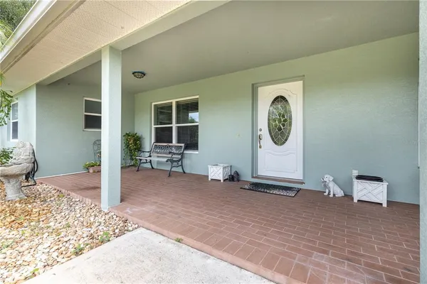 a view of a livingroom with wooden floor and furniture