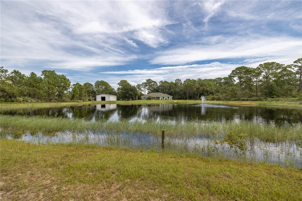 4245 Clinton Cemetery Road Edgewater, FL 32141 - Photo 41 of 60 a view of a lake with houses in the back