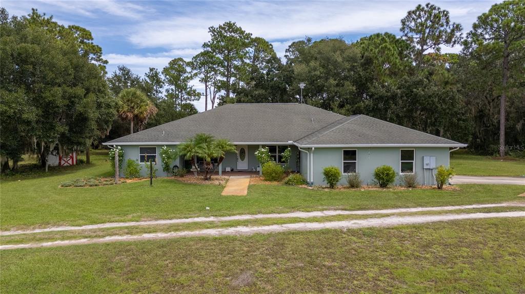4245 Clinton Cemetery Road Edgewater, FL 32141 - Photo 42 of 60 a backyard of a house with table and chairs