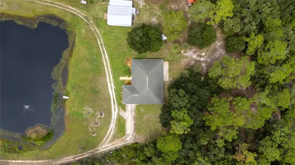 an aerial view of a house with a yard