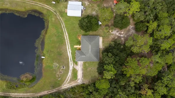 an aerial view of a house with a garden and a yard