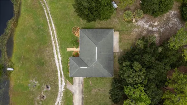 an aerial view of a house with a yard