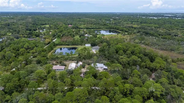 an aerial view of a house with a tree