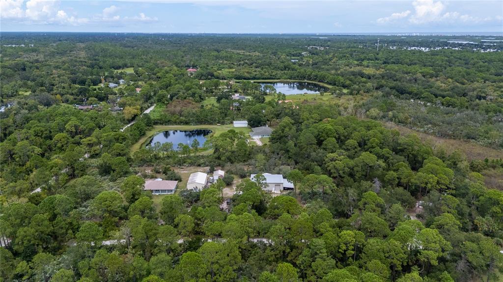 4245 Clinton Cemetery Road Edgewater, FL 32141 - Photo 48 of 60 an aerial view of a city with lots of residential buildings