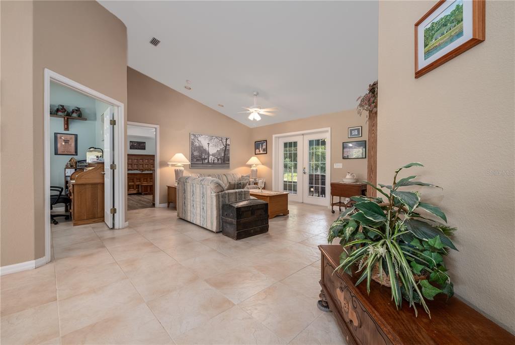 4245 Clinton Cemetery Road Edgewater, FL 32141 - Photo 7 of 60 a living room with furniture and a potted plant