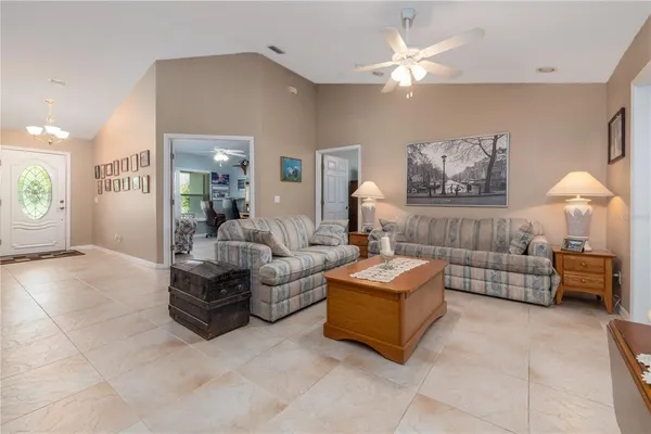 a living room with furniture and a book shelf