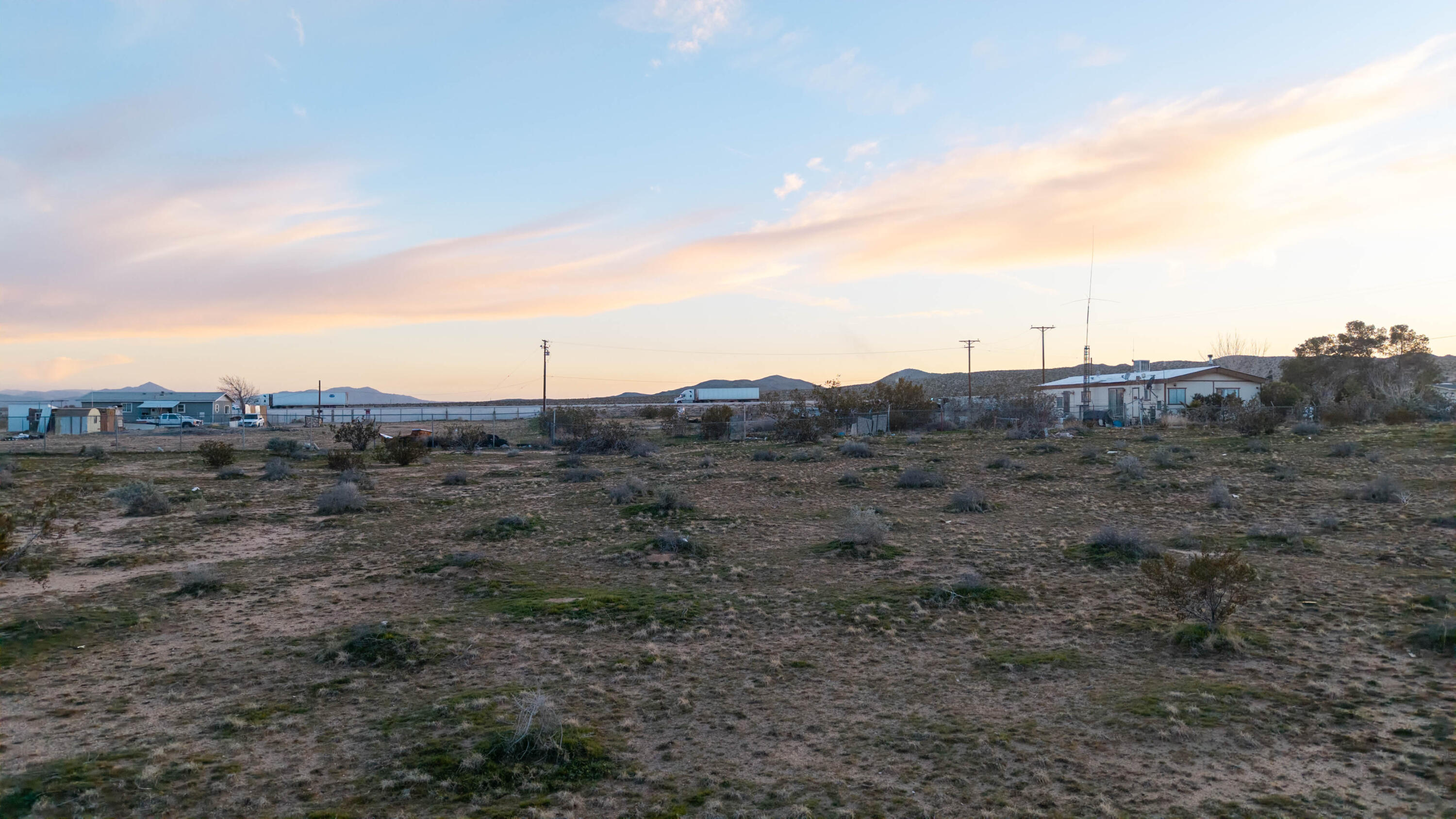 263 Hidden River Road Hinkley, CA 92347 - Photo 8 of 8 a view of a dry field with trees in the background