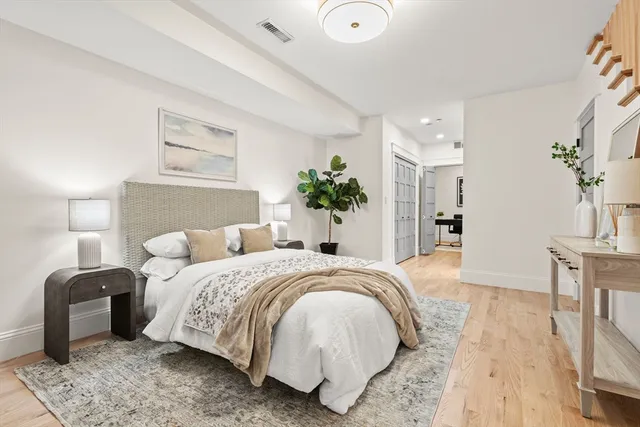 a bedroom with a bed and a chandelier