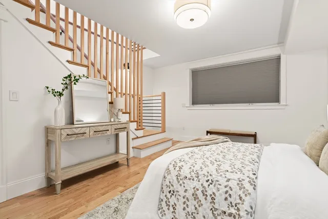 a bedroom with a bed and a potted plant