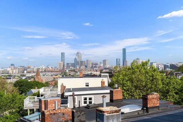 an aerial view of a city with swimming pool and lake view