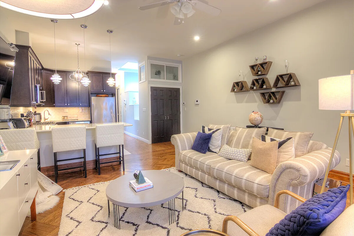 259 West 90th Street, Unit 4 Manhattan, NY 10024 - Photo 2 of 14 a living room with furniture and kitchen view