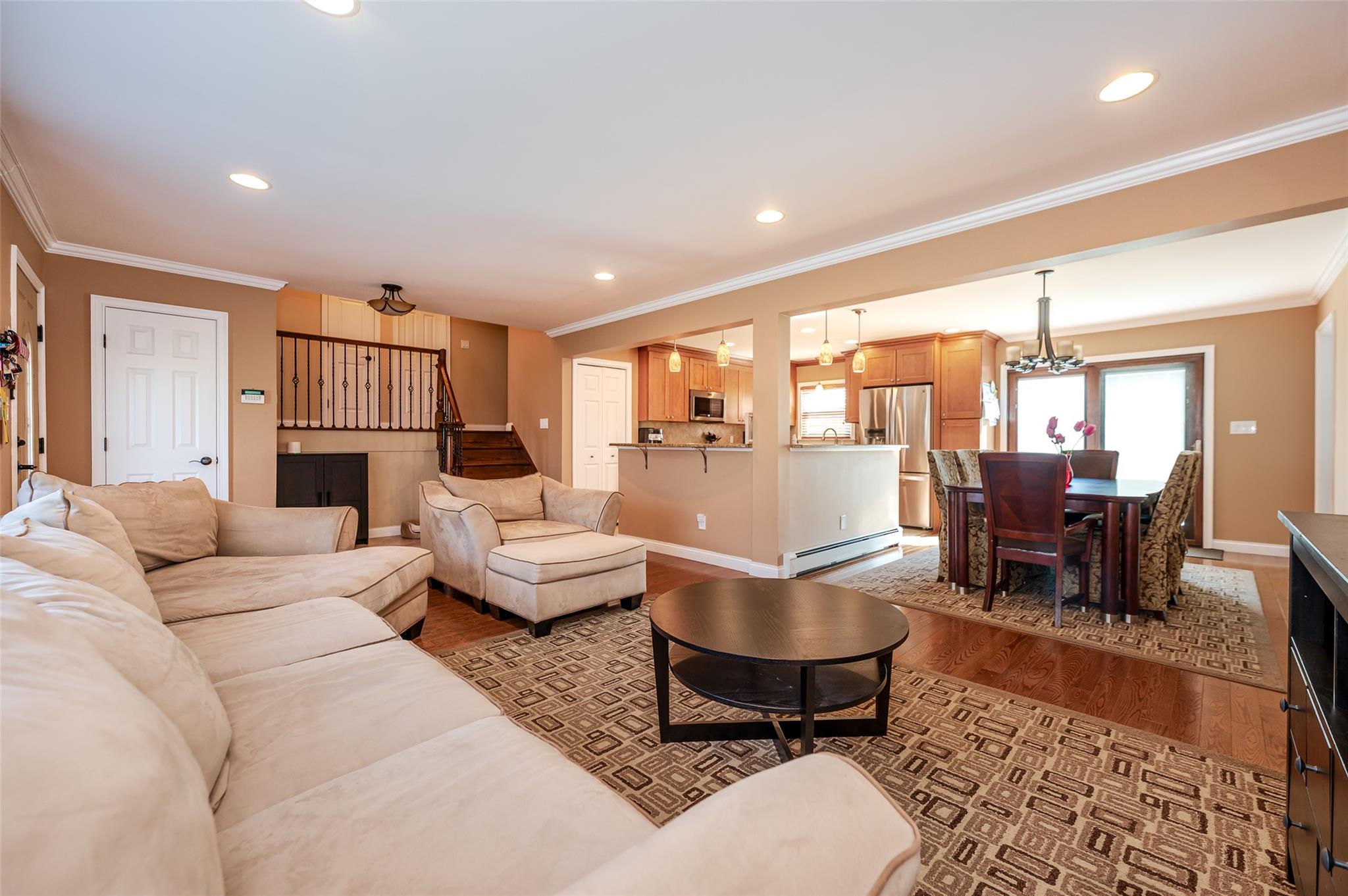 a living room with furniture wooden floor and a table