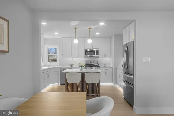 a kitchen with stainless steel appliances granite countertop a refrigerator and a stove top oven
