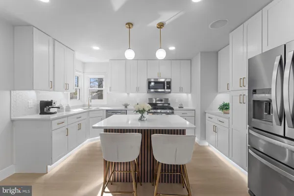 a kitchen with refrigerator cabinets dining table and chairs