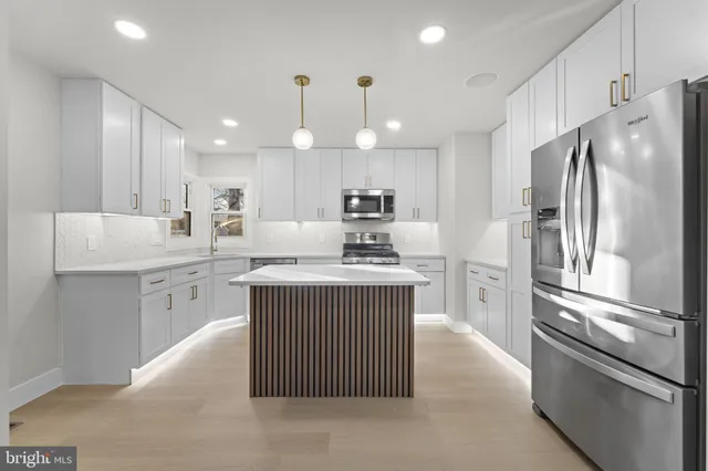 a kitchen with a refrigerator stove and microwave
