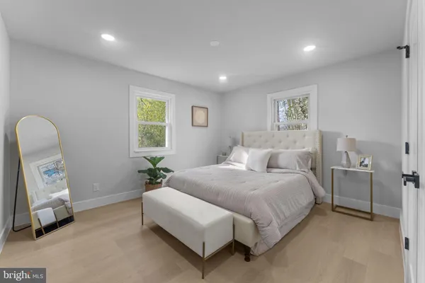 a spacious bedroom with a bed a couch and a window