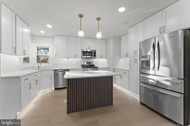 a kitchen that has a sink and a stove in it