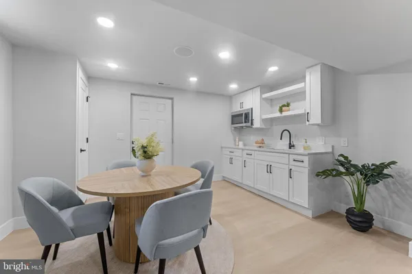a kitchen with a table and chairs
