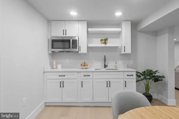 a kitchen with stainless steel appliances white cabinets and a sink