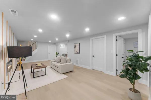 a living room with furniture and a potted plant