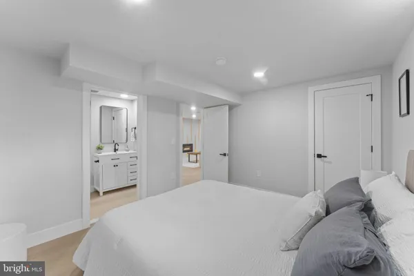 a bedroom with a bed and a large mirror