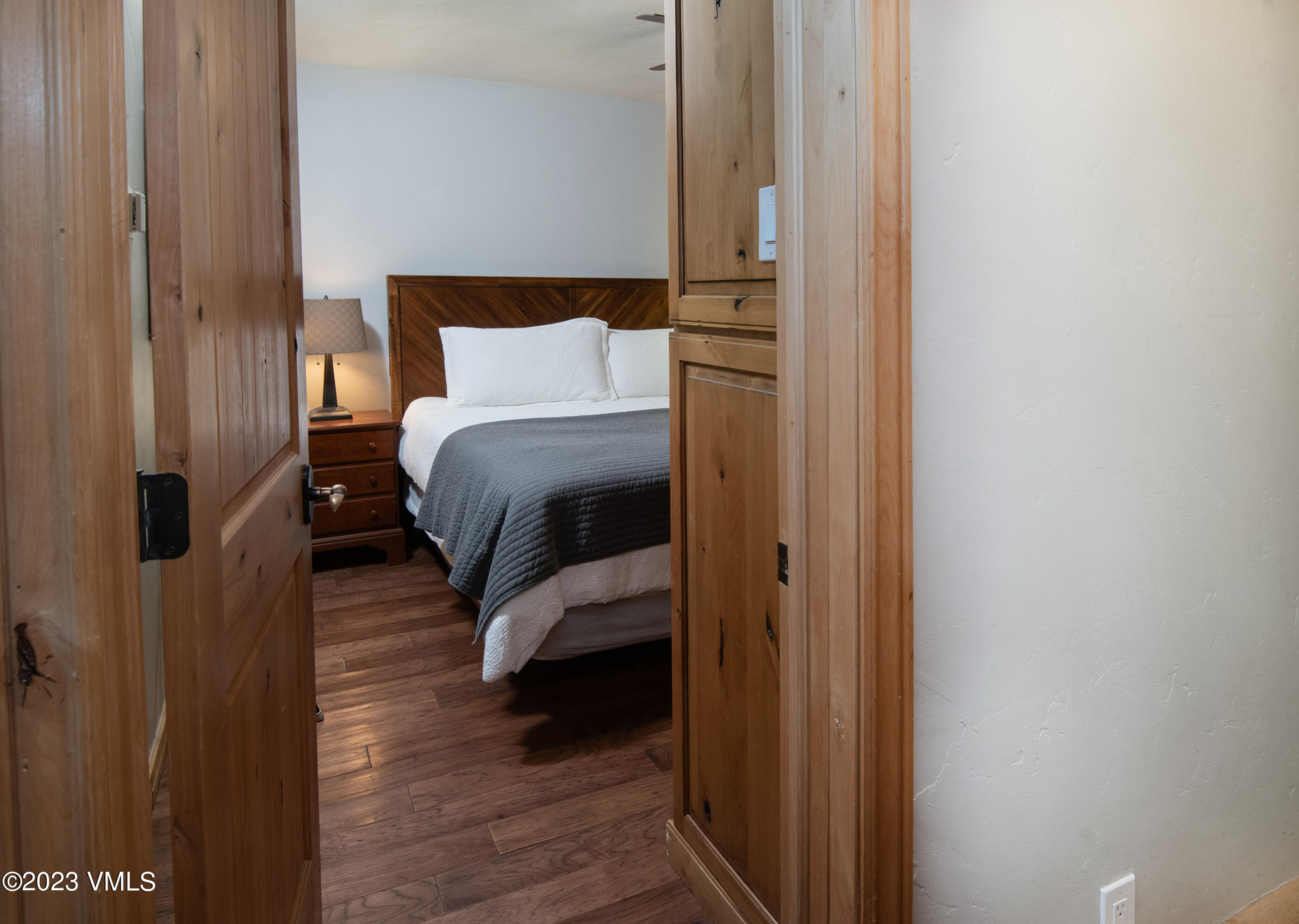 442 South Frontage Road East, Unit 103B Vail, CO 81657 - Photo 13 of 32 a bed room with a bed and a mirror