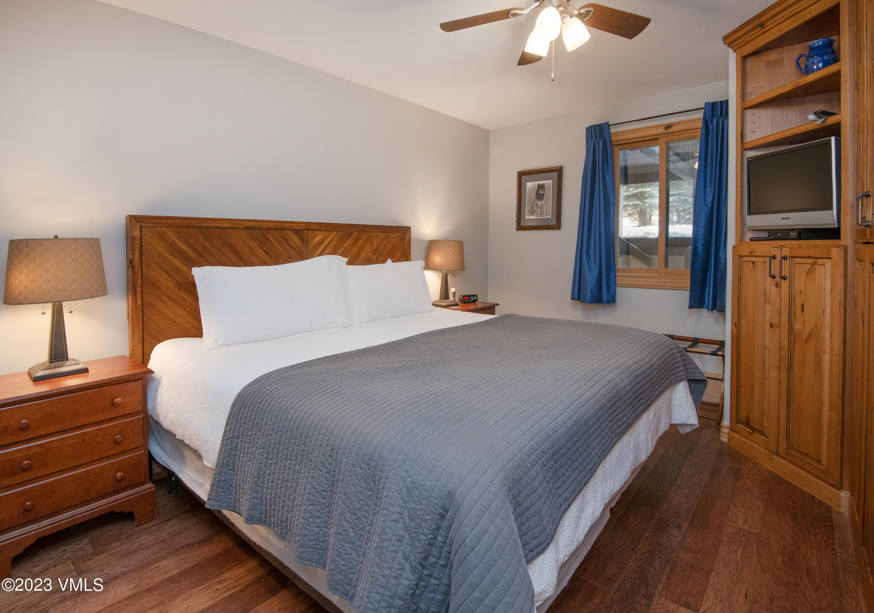 442 South Frontage Road East, Unit 103B Vail, CO 81657 - Photo 14 of 32 a bedroom with a bed and a flat tv screen on dresser