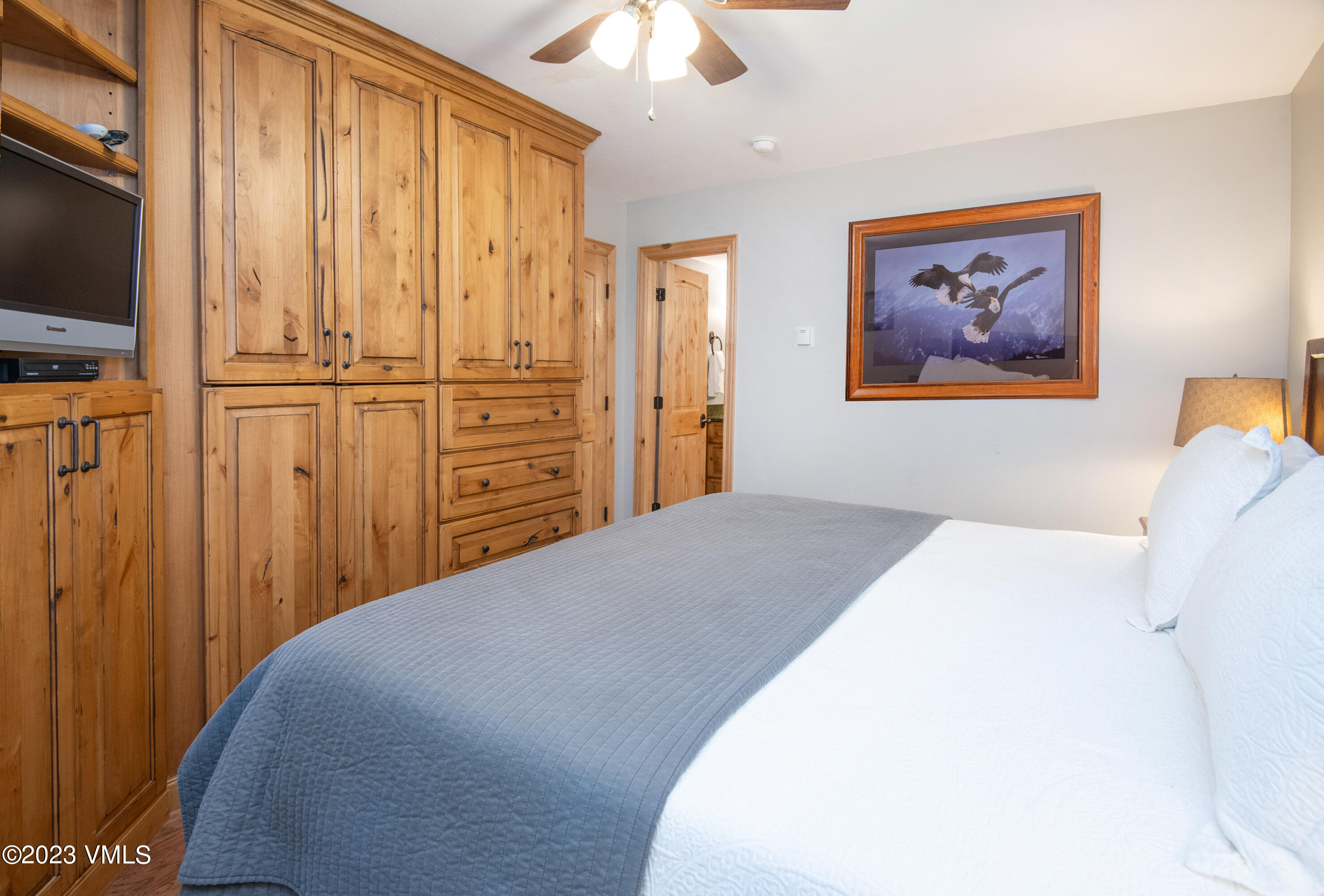 442 South Frontage Road East, Unit 103B Vail, CO 81657 - Photo 15 of 32 a bedroom with a bed and a chandelier