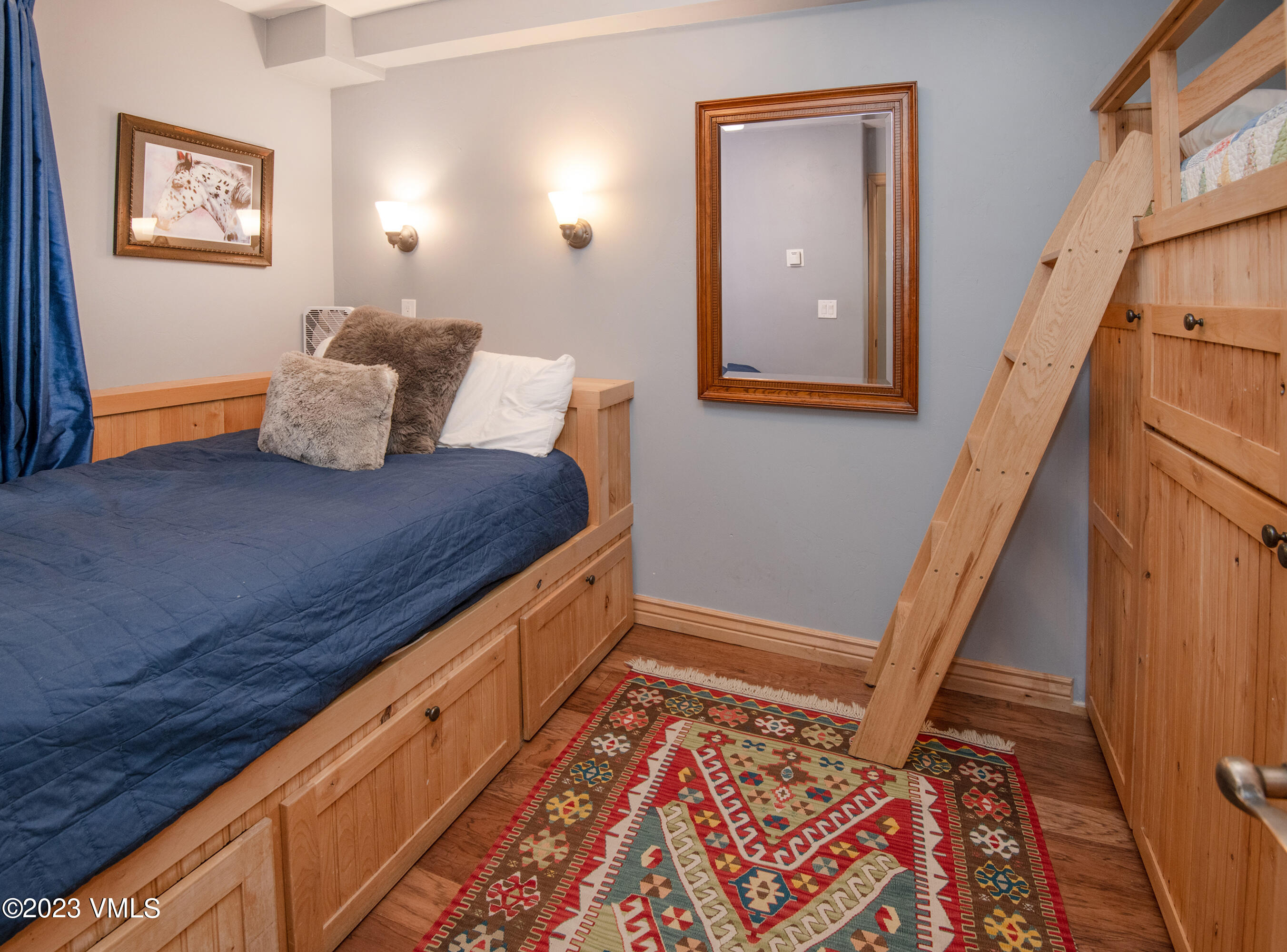 442 South Frontage Road East, Unit 103B Vail, CO 81657 - Photo 17 of 32 a view of bedroom with furniture and wooden floor