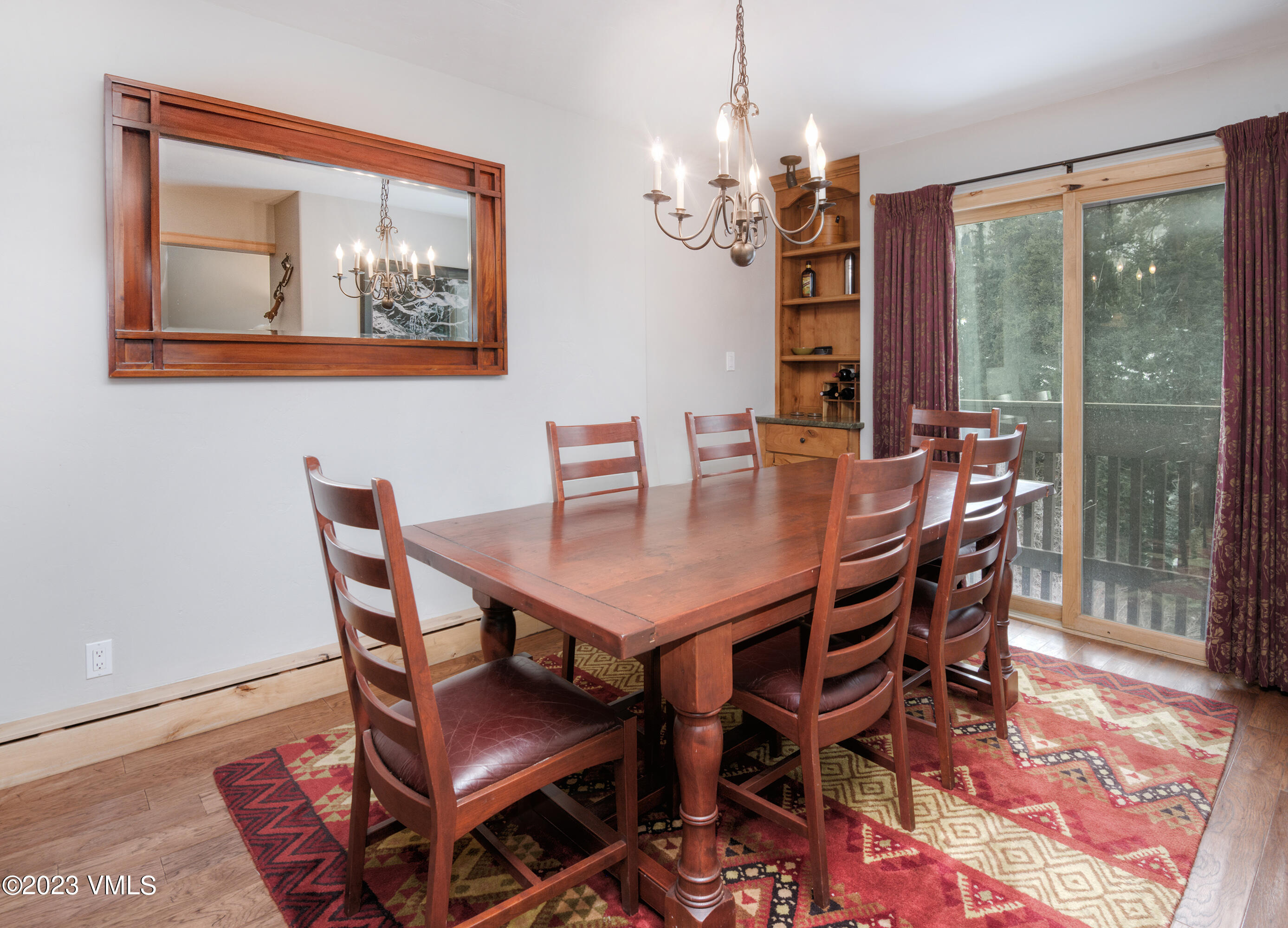 442 South Frontage Road East, Unit 103B Vail, CO 81657 - Photo 5 of 32 a view of a dining room with furniture wooden floor and chandelier