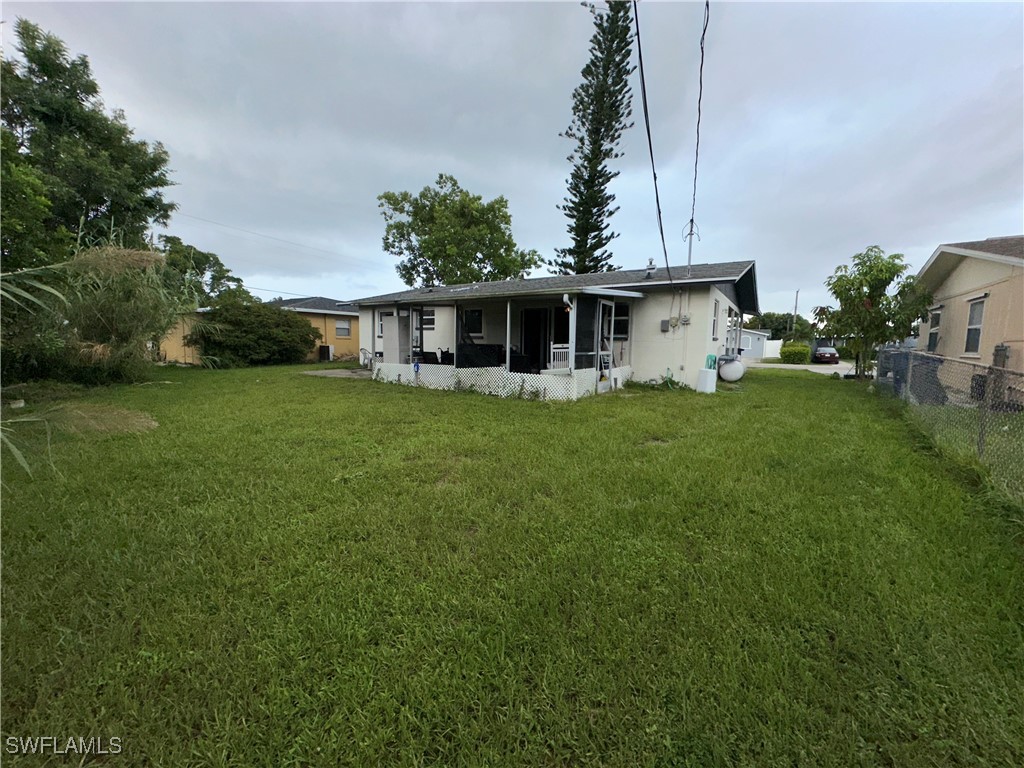 2196 Barry Drive Fort Myers, FL 33907 - Photo 14 of 17 a view of a house with a big yard and potted plants
