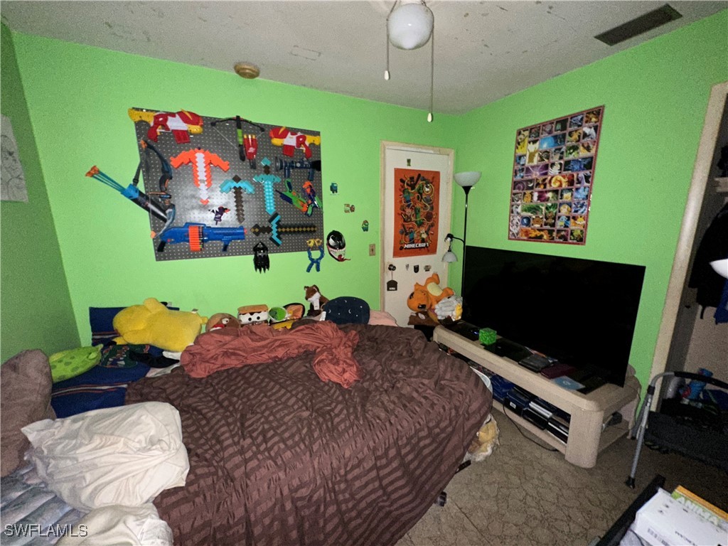2196 Barry Drive Fort Myers, FL 33907 - Photo 4 of 17 a bedroom with a bed and flat screen tv