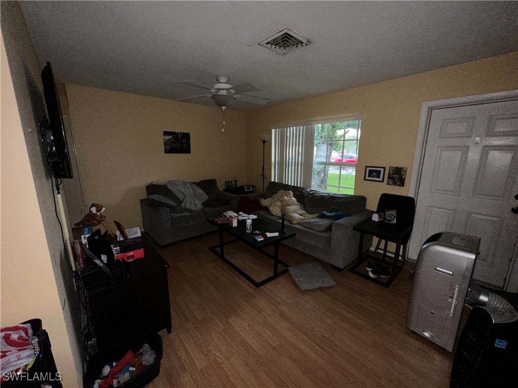 2196 Barry Drive Fort Myers, FL 33907 - Photo 7 of 17 a living room with furniture window and wooden floor
