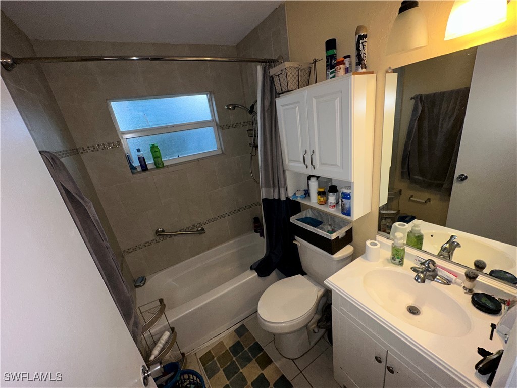 2196 Barry Drive Fort Myers, FL 33907 - Photo 10 of 17 a bathroom with a sink toilet and shower