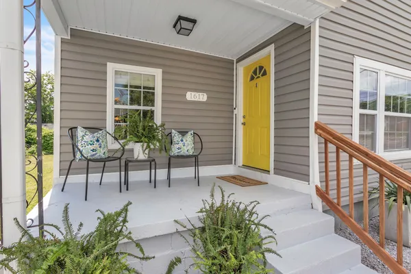 a view of a porch with chairs and potted plants